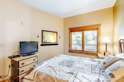 a bedroom with a bed and a tv on a dresser at 1 Bedroom Colorado Vacation Rental In River Run Village Steps From The Summit Express Gondola in Keystone