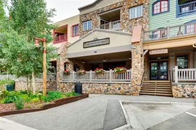 a building with a sign on the front of it at 1 Bedroom Colorado Vacation Rental In River Run Village Steps From The Summit Express Gondola in Keystone