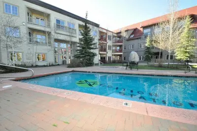 a large swimming pool in front of a building at 1 Bedroom Colorado Vacation Rental In River Run Village Steps From The Summit Express Gondola in Keystone
