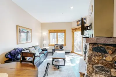 a living room with a couch and a fireplace at 1 Bedroom Colorado Vacation Rental In River Run Village Steps From The Summit Express Gondola in Keystone