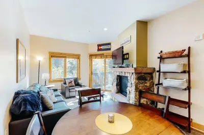 a living room with a couch and a fireplace at 1 Bedroom Colorado Vacation Rental In River Run Village Steps From The Summit Express Gondola in Keystone