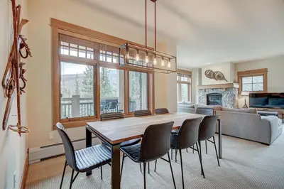 a dining room with a wooden table and chairs at Premier 3 Bedroom Ski In, Ski Out Lone Eagle Condo With The Best Access To Skiing In Keystone in Keystone