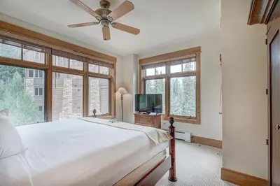 a bedroom with a bed and a ceiling fan at Premier 3 Bedroom Ski In, Ski Out Lone Eagle Condo With The Best Access To Skiing In Keystone in Keystone