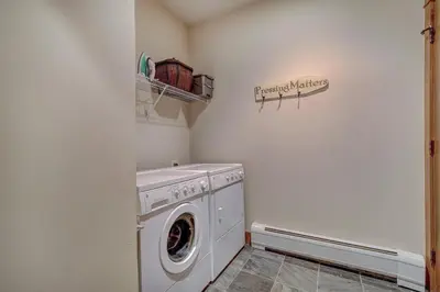 a laundry room with a washer and dryer at Premier 3 Bedroom Ski In, Ski Out Lone Eagle Condo With The Best Access To Skiing In Keystone in Keystone