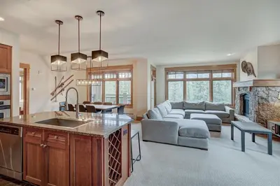 a kitchen and living room with a couch and a fireplace at Premier 3 Bedroom Ski In, Ski Out Lone Eagle Condo With The Best Access To Skiing In Keystone in Keystone