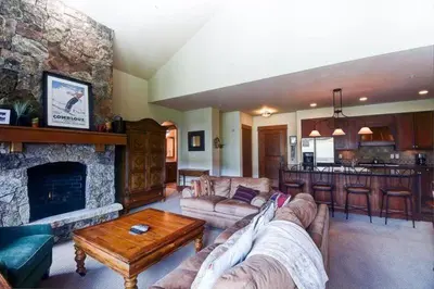 a living room with a couch and a fireplace at Premier 4 Bedroom Ski In, Ski Out Lone Eagle Condo With The Best Access To Skiing In Keystone in Keystone