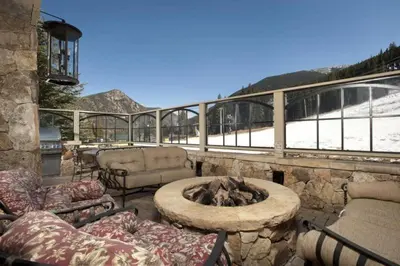 a stone patio with a fire pit on a balcony at Premier 4 Bedroom Ski In, Ski Out Lone Eagle Condo With The Best Access To Skiing In Keystone in Keystone