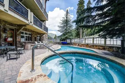 a swimming pool in the middle of a house at Premier 4 Bedroom Ski In, Ski Out Lone Eagle Condo With The Best Access To Skiing In Keystone in Keystone