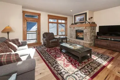 a living room with a couch and a fireplace at Premier 2 Bedroom Ski In, Ski Out Lone Eagle Condo With The Best Access To Skiing In Keystone in Keystone
