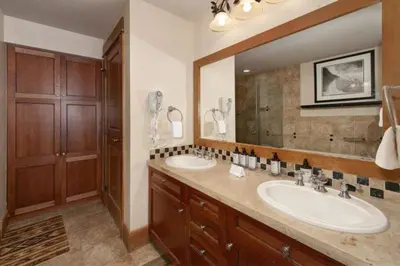 a bathroom with two sinks and a large mirror at Premier 2 Bedroom Ski In, Ski Out Lone Eagle Condo With The Best Access To Skiing In Keystone in Keystone