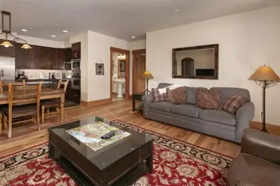 a living room with a couch and a dining room at Premier 2 Bedroom Ski In, Ski Out Lone Eagle Condo With The Best Access To Skiing In Keystone in Keystone