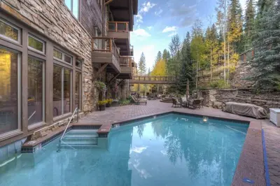 a swimming pool in the backyard of a house at Premier 2 Bedroom Ski In, Ski Out Vacation Rental At The Timbers With The Best Access To Skiing In Keystone in Keystone