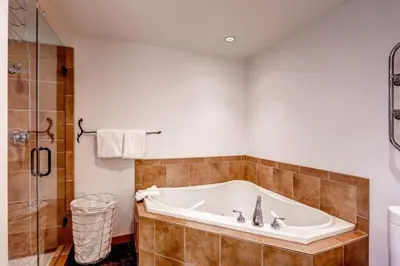 a large bathroom with a tub and a shower at Premier 2 Bedroom Ski In, Ski Out Vacation Rental At The Timbers With The Best Access To Skiing In Keystone in Keystone