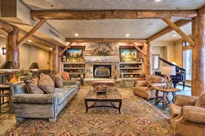 a large living room with a stone fireplace at Premier 2 Bedroom Ski In, Ski Out Vacation Rental At The Timbers With The Best Access To Skiing In Keystone in Keystone
