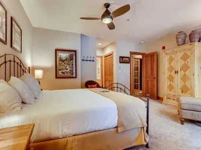 a bedroom with a large bed and a ceiling fan at Premier 2 Bedroom Ski In, Ski Out Vacation Rental At The Timbers With The Best Access To Skiing In Keystone in Keystone