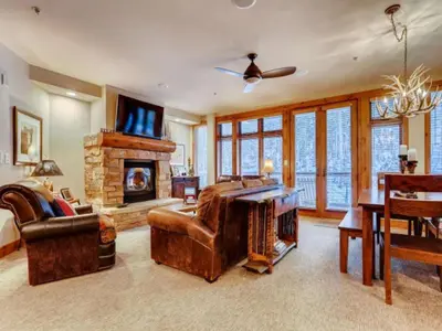 a living room with a couch and a fireplace at Premier 2 Bedroom Ski In, Ski Out Vacation Rental At The Timbers With The Best Access To Skiing In Keystone in Keystone