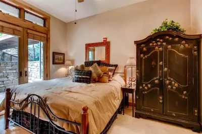 a bedroom with a large bed and a mirror at Premier 3 Bedroom Timbers Ski In, Ski Out Vacation Rental At The Timbers With The Best Access To Skiing In Keystone in Keystone