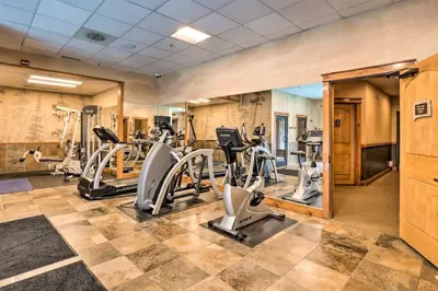 a gym with treadmills and elliptical machines at Premier 3 Bedroom Timbers Ski In, Ski Out Vacation Rental At The Timbers With The Best Access To Skiing In Keystone in Keystone