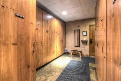 a hallway with wooden walls and a bench in a room at Premier 3 Bedroom Timbers Ski In, Ski Out Vacation Rental At The Timbers With The Best Access To Skiing In Keystone in Keystone