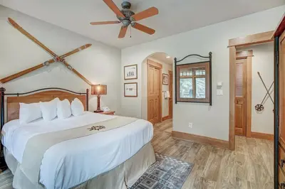 a bedroom with a large bed and a ceiling fan at Premier 1 Bedroom Ski In, Ski Out Lone Eagle Condo With The Best Access To Skiing In Keystone in Keystone