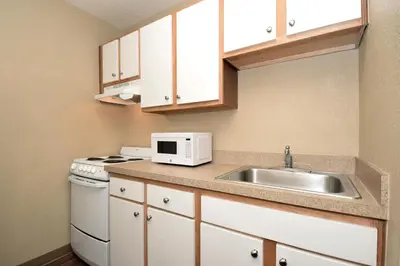 a small kitchen with a sink and a microwave at Extended Stay America Select Suites - Denver - Tech Center South in Centennial