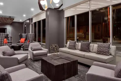 a living room with couches and chairs and a table at TownePlace Suites by Marriott Loveland Fort Collins in Loveland