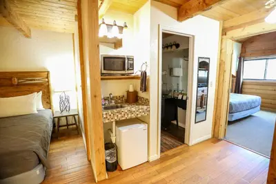 a bedroom with a bed and a sink in a room at The Boulder Creek Lodge in Nederland