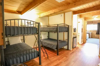 two bunk beds in a room with wooden ceilings at The Boulder Creek Lodge in Nederland