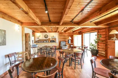a restaurant with tables and chairs in a room at The Boulder Creek Lodge in Nederland