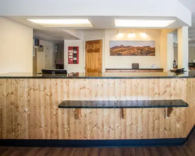a bar in an office with a wooden counter top at Rodeway Inn Greeley in Evans