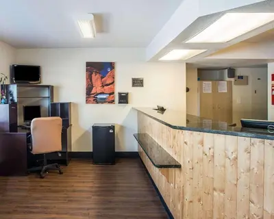 an office with a bar and a desk with a chair at Rodeway Inn Greeley in Evans