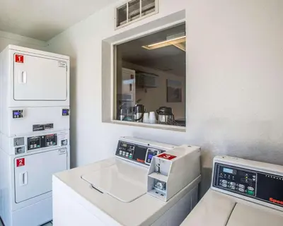 a kitchen with a counter with a sewing machine at Rodeway Inn Greeley in Evans