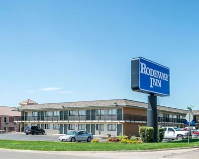 a blue street sign in front of a building at Rodeway Inn Greeley in Evans