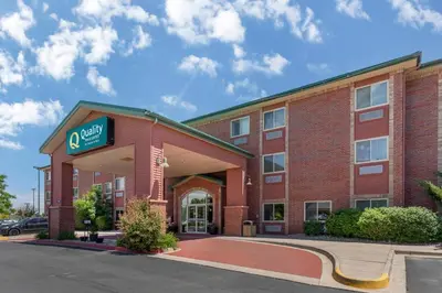 a large red brick building with a sign on it at Quality Inn & Suites Wellington - Fort Collins in Wellington