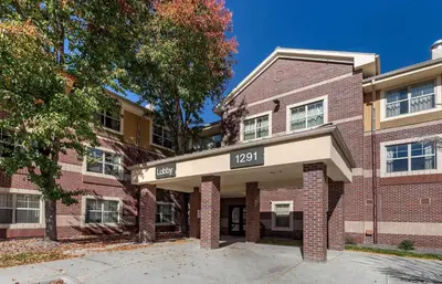 a brick building with a sign that says at Extended Stay America Suites - Denver - Westminster in Westminster
