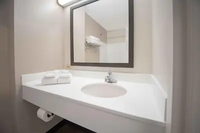 a white bathroom with a sink and a mirror at Extended Stay America Suites - Denver - Westminster in Westminster