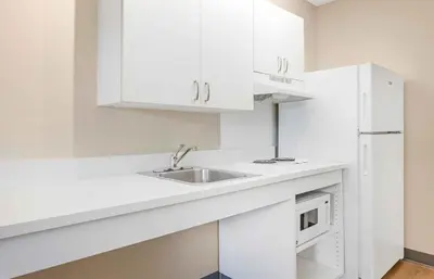 a white kitchen with a sink and a microwave at Extended Stay America Suites - Denver - Westminster in Westminster
