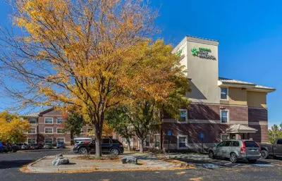 a tree in a parking lot in front of a building at Extended Stay America Suites - Denver - Westminster in Westminster