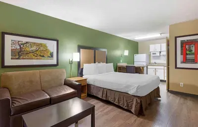 a hotel room with a bed and a couch at Extended Stay America Select Suites - Denver - Cherry Creek in Denver