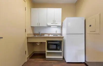 a kitchen with a white refrigerator and a sink at Extended Stay America Select Suites - Denver - Lakewood South in Lakewood