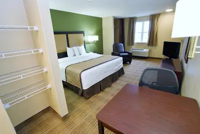 a hotel room with a bed and a desk at Extended Stay America Select Suites - Denver - Lakewood South in Lakewood
