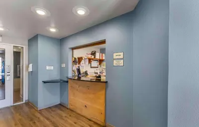 a room with a counter and a blue wall at Extended Stay America Select Suites - Denver - Aurora in Aurora