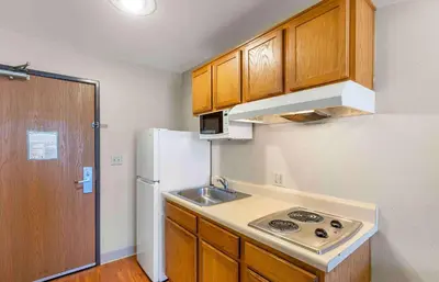 a small kitchen with a sink and a refrigerator at Extended Stay America Select Suites - Denver - Aurora in Aurora
