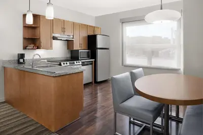 a kitchen with a table and a counter top at Hyatt House Boulder/Broomfield in Broomfield