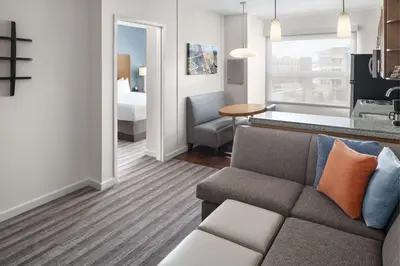 a living room with a couch and a bedroom at Hyatt House Boulder/Broomfield in Broomfield