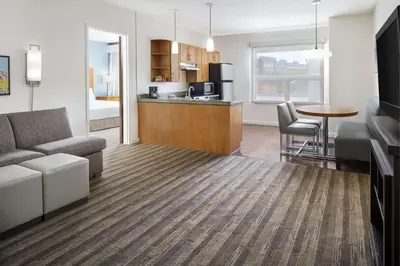 a living room with a couch and a table and a kitchen at Hyatt House Boulder/Broomfield in Broomfield