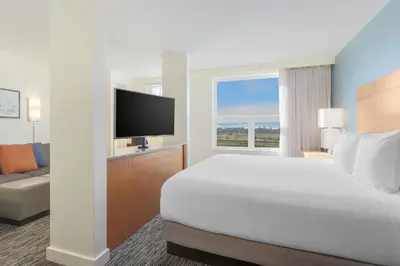 a hotel room with a bed and a television at Hyatt House Denver Airport in Denver