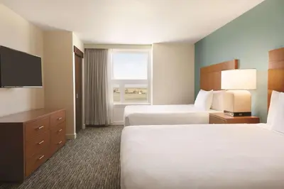 a hotel room with two beds and a window at Hyatt House Denver Airport in Denver