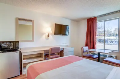 a hotel room with a bed and a desk and a television at Motel 6-Greenwood Village, CO - Denver - South Tech Center in Greenwood Village