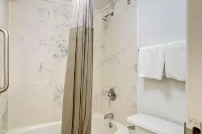 a bathroom with a shower and a tub and a toilet at Motel 6-Greenwood Village, CO - Denver - South Tech Center in Greenwood Village